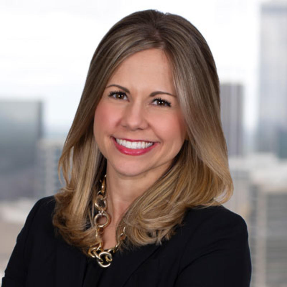 Headshot of a smiling woman with blonde hair